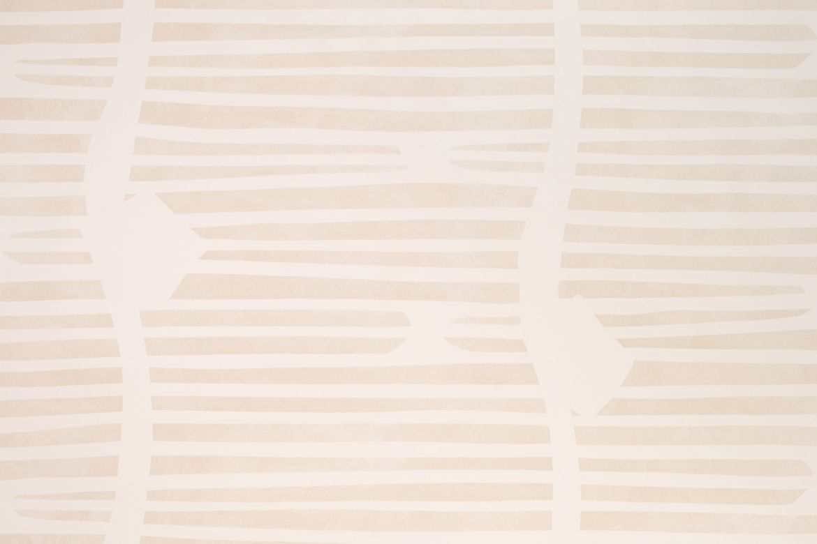 Shore Lines Wallpaper in Vanilla features soft cream and pale sand stripes, evoking sun-bleached coastal tones with a painterly, abstract finish.
