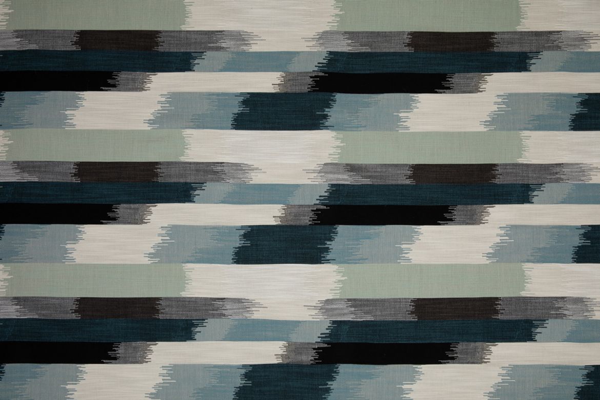 SOMBRE Perennials Performance Ikat Woven Fabric in a blue, green, white and black colours. Designed for outdoor upholstery and furniture.
