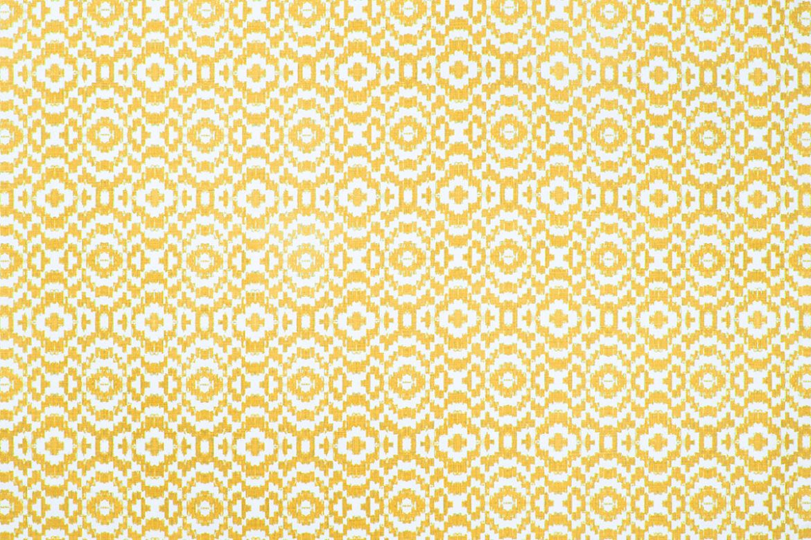 Echo Printed Fabric in Lemon, featuring a soft yellow ikat-inspired circular pattern on natural linen, adding brightness and movement to interiors.