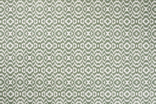 Echo Printed Fabric in Olive, showcasing a muted green ikat-style circle pattern on natural linen, ideal for warm, earthy interior schemes.