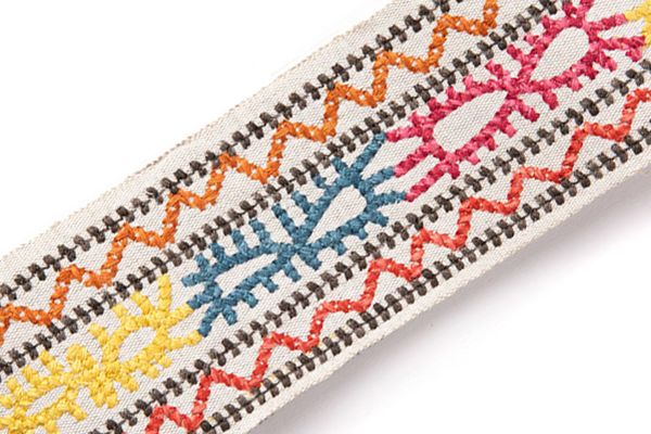 Caravanne Border Trim in Orange – tonal and multicolour Aztec-style embroidery stitched over natural linen tape