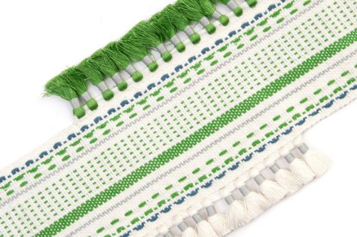 Pom Parade Border Trim in green — stitched stripe border with contrasting tasselled trims in blue and natural tones, creating a vibrant and playful finish.