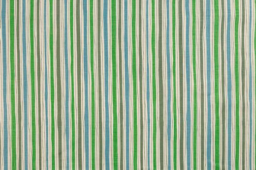 And Objects Boundary striped linen fabric in blue and olive green and bright green hues, featuring a playful abstract stripe pattern, designed by And Objects for Christopher Farr Cloth.