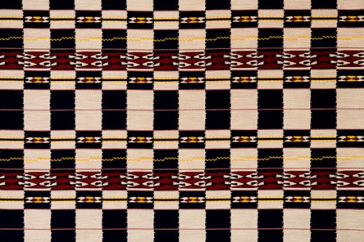 Chubby Check Woven Fabric in Indigo, with deep blue, burgundy, yellow, and natural checks. A bold design for sophisticated upholstery and home decor.