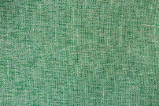 Denali Plain Woven Fabric in Green, featuring a vibrant emerald green tone with a rich, textured weave, adding energy and a refreshing natural touch to any interior.