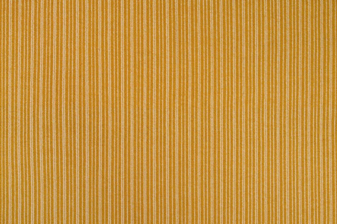 Divide Woven Fabric in Lemon, featuring a two-tone stripe in warm yellow and neutral tones, adding a soft, earthy brightness to interior schemes.