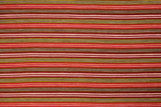 A lively stripe weave in hot pink hues, layered with complementary multicoloured threads that add depth, warmth, and playful energy to the design.