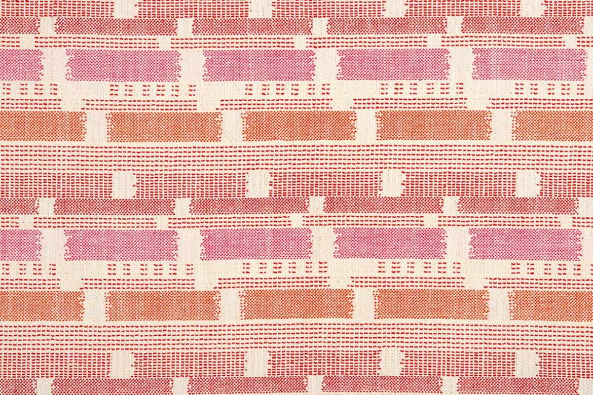 Loom Weave woven fabric in Hot Pink, featuring a bold mix of orange, pink, and natural tones. A richly textured textile with vibrant artisan flair.