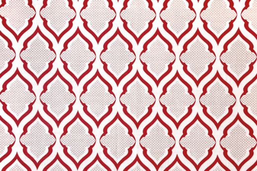 Ravenna Printed Fabric in Ruby – deep red and neutral hues create a striking geometric pattern on linen, bringing warmth and graphic sophistication to interiors.