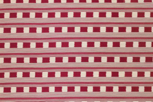 Lost and Found fabric in ruby red, featuring a woven check pattern with contrasting coloured stripes. This rich and warm tone brings a dynamic, bold touch to any space, ideal for statement upholstery and custom soft furnishings.