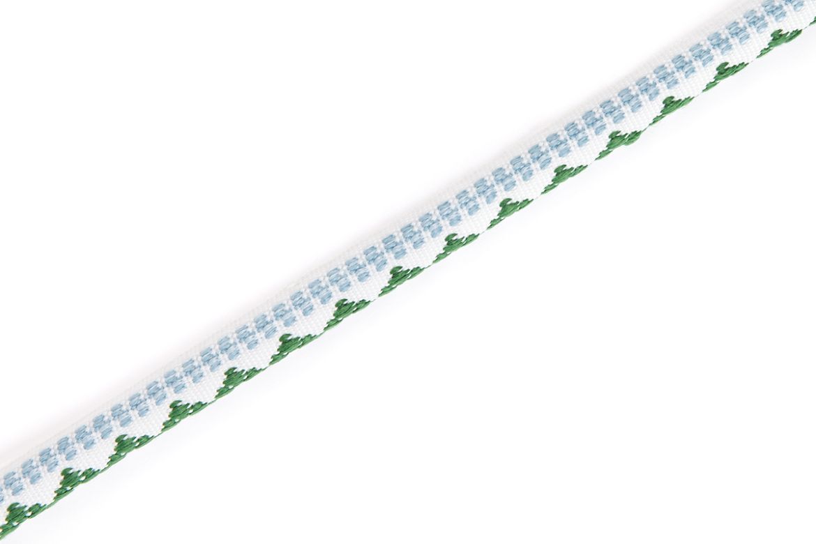 Verde: Pyramid Performance Piping in green and pale blue with embroidered geometric detail on neutral ground.