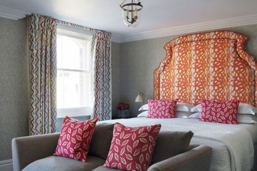 Fathom Hot Pink upholstered headboard. Interior by Kit Kemp, Location at Firmdale Hotels, Photography by Simon Brown