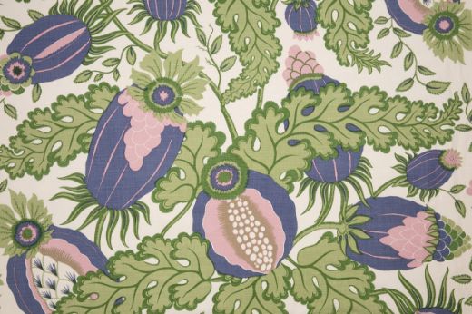 Christopher Farr Cloth Carnival Indoor Print Blueberry. A detailed botanical illustration featuring large stylised flowers in shades of purple, green and pink, with intricate leaves and stems on a light background. 