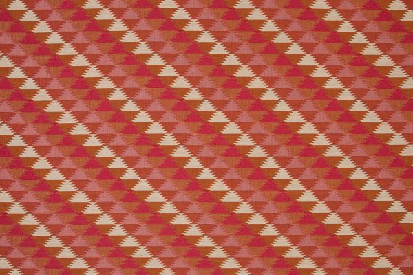 Woven fabric in pinks and reds colours in a geometric pattern  
