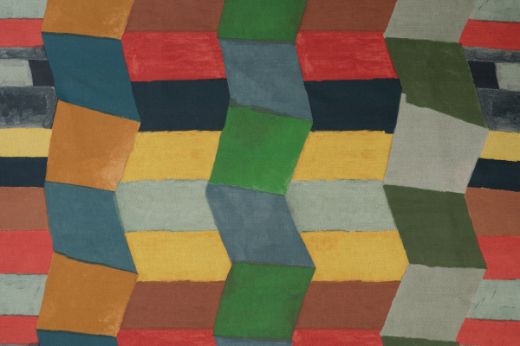 Bright colourful geometric blocks fit together to create a zig zag pattern in blues, greens and yellows.