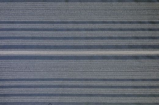 Saint Tropez Outdoor Woven Fabric in Notte – deep navy blue stripes with a sophisticated woven texture, adding richness and depth to outdoor spaces.