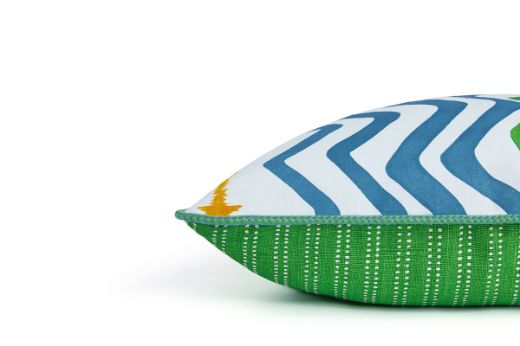 Side view of Rick Rack cushion in green, featuring Rick Rack Green and Algonquin striped design and finished with vibrant Circus piping for a bold, artisanal look.